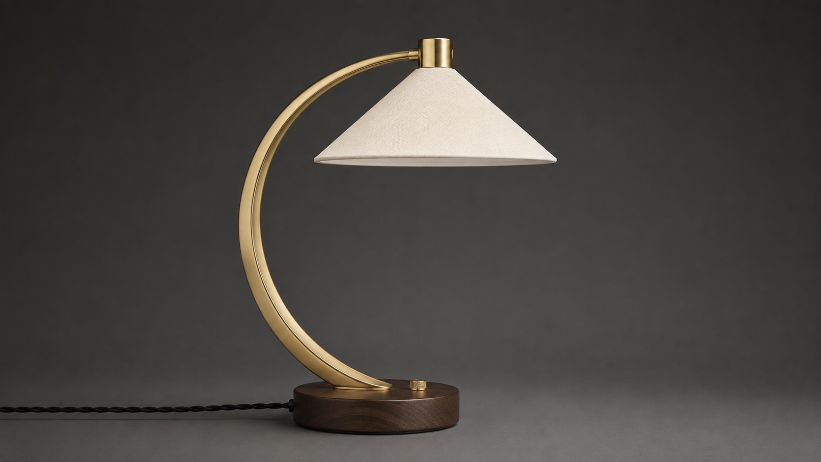 Image 2: side view of the same brass desk lamp