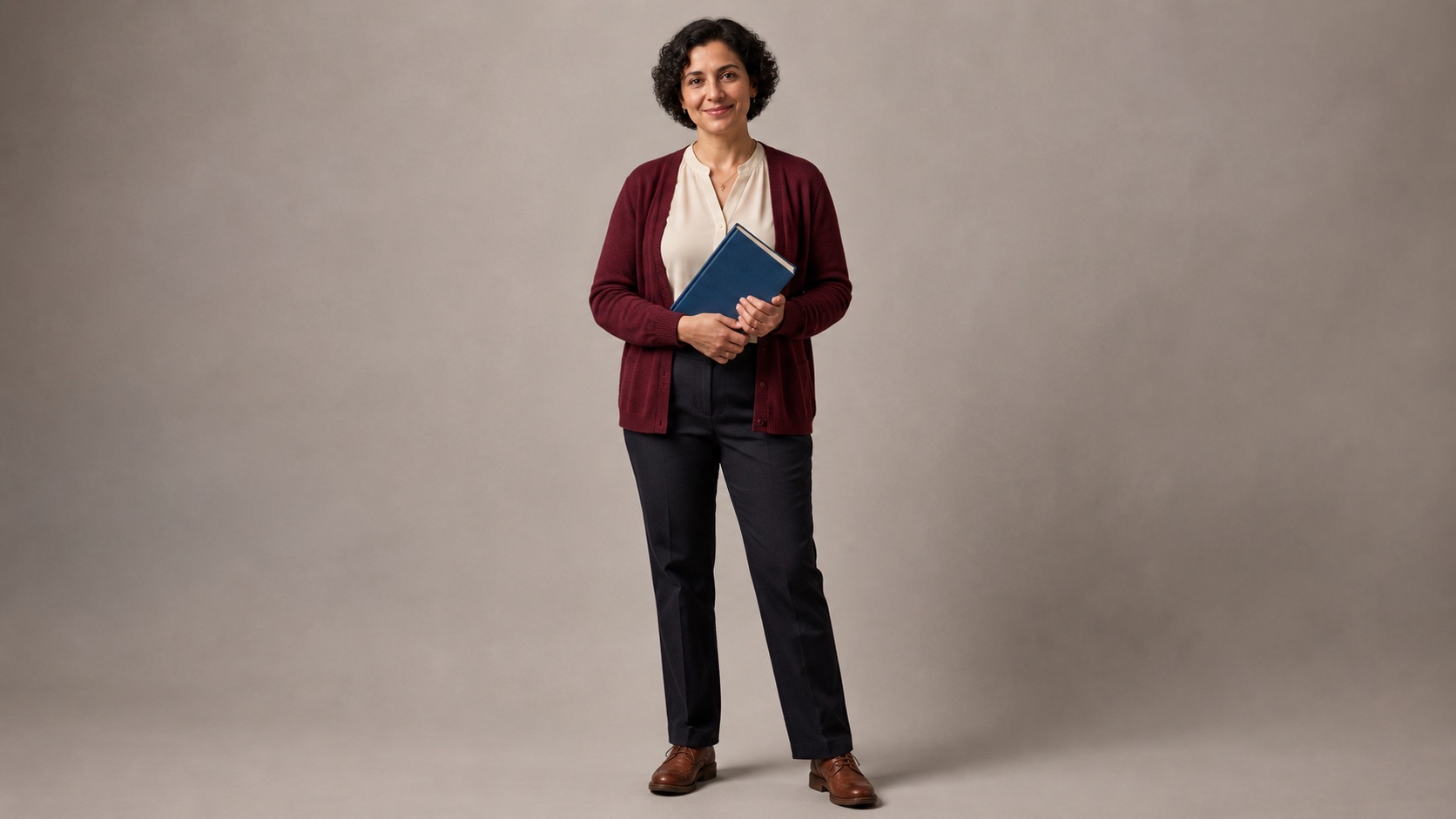 Image 2: a standalone portrait of the adult bookseller in a burgundy cardigan